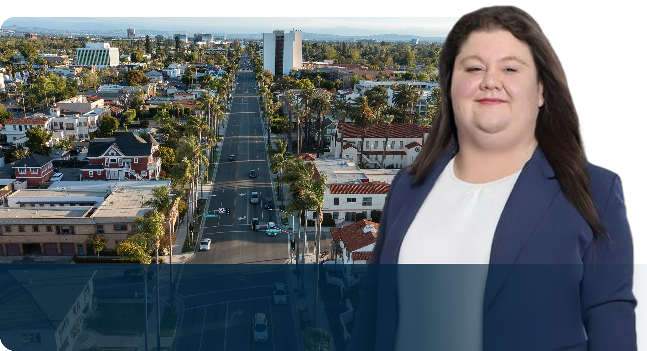 A woman standing in front of an aerial view of the city.