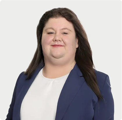 A woman in a blue jacket and white shirt