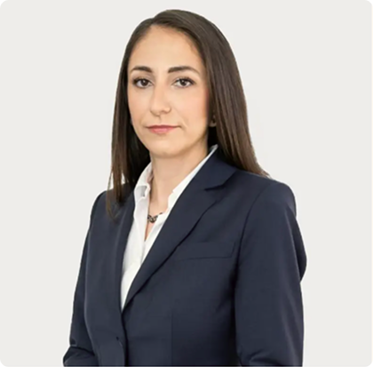 A woman in a suit and white shirt